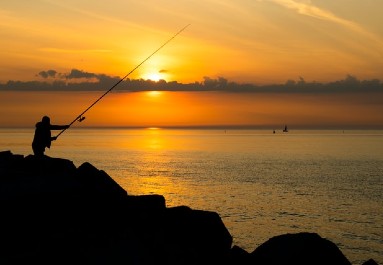 man fishing in the sunset